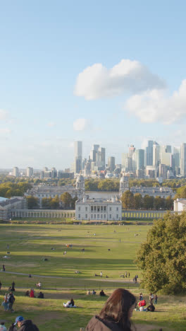 Vertical-Video-Of-Old-Royal-Naval-College-With-City-Skyline-And-River-Thames-Behind-From-Royal-Observatory-In-Greenwich-Park